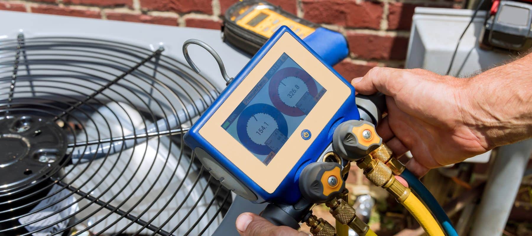 air conditioning tech using a tool on an air conditioning unit