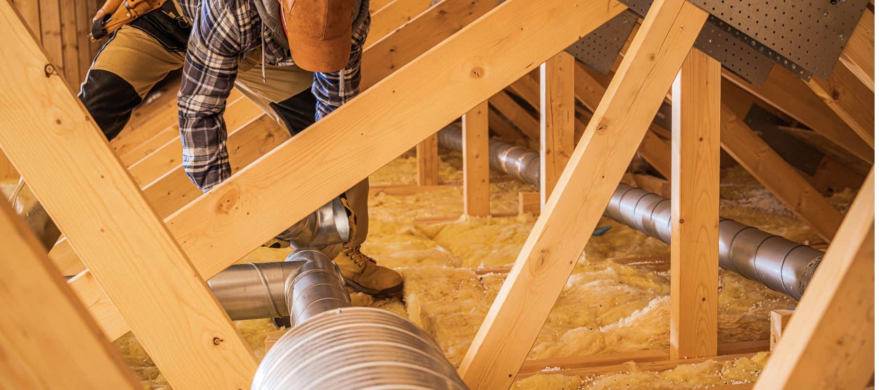 tech in an attic installing new air ducts