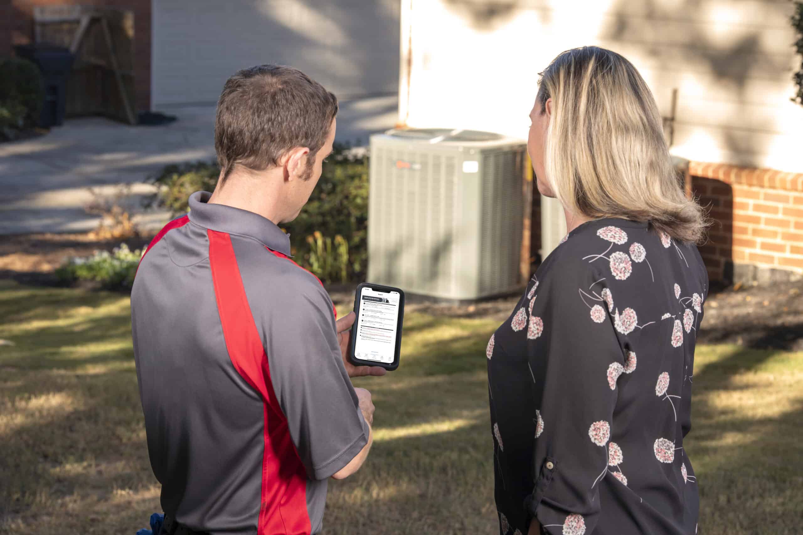 HVAC technician with homeowner in college station texas